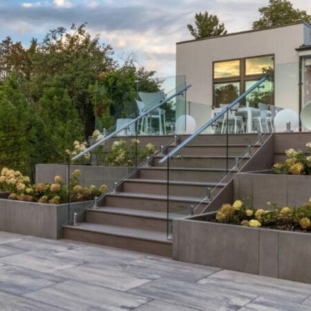 A beautiful backyard deck arrangement created with Artex Panel System provided by Hard-Co's landscape supply in Whitby