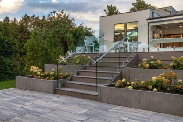 A beautiful backyard deck arrangement created with Artex Panel System provided by Hard-Co's landscape supply in Whitby