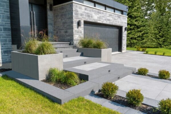 An impressive front stair & driveway arrangement created with Artex Panel Systems provided by Hard-Co's landscape supply in Whitby